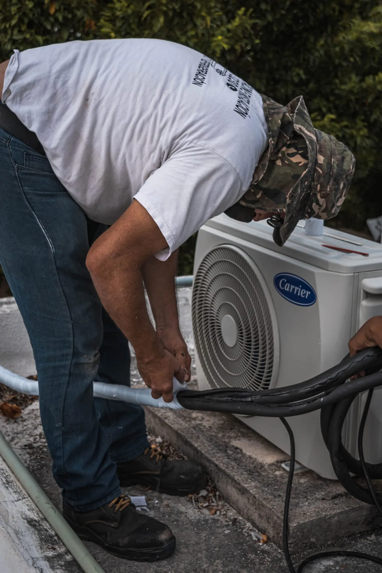 Technician servicing an outdoor air-conditioning unit