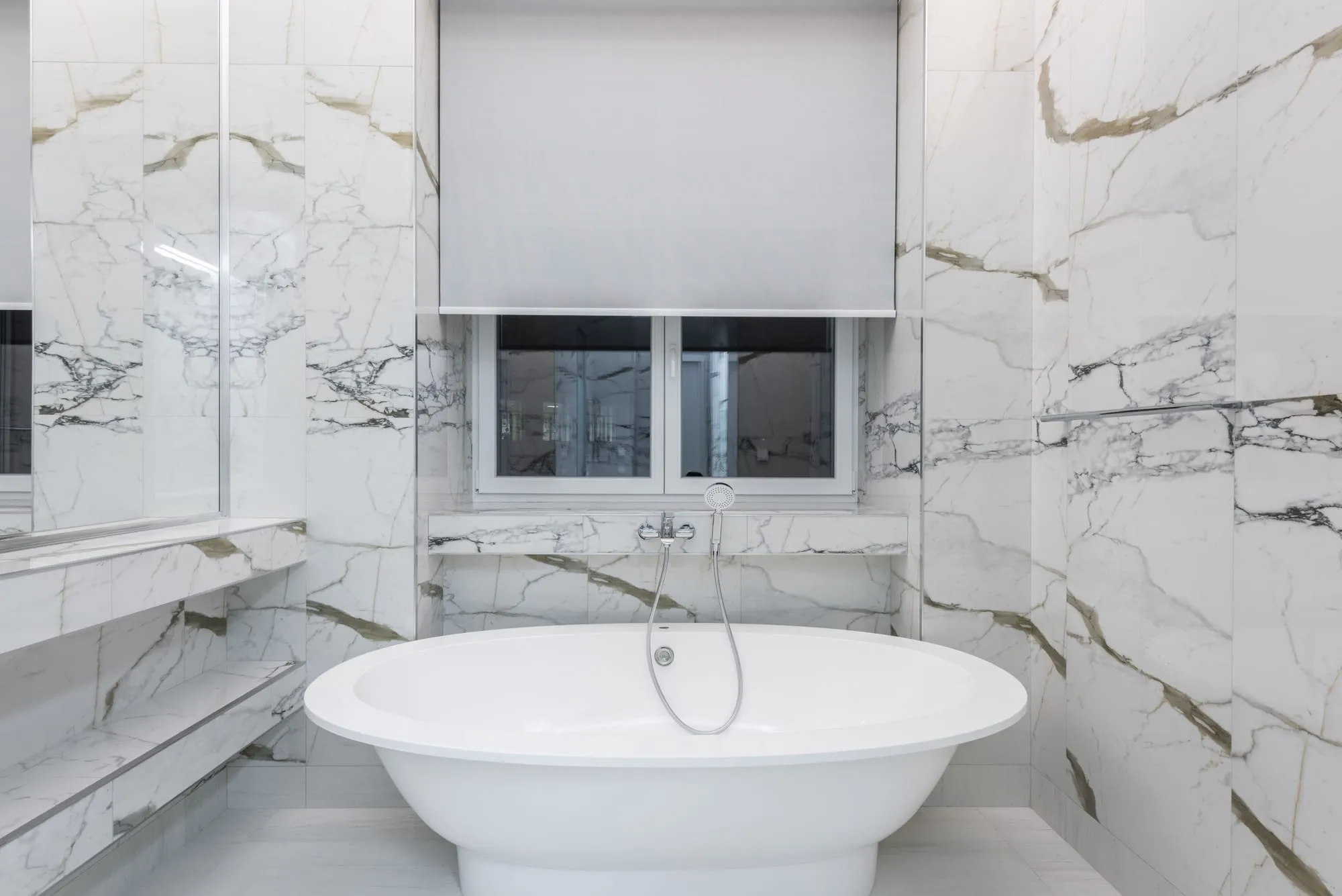 White marble bathroom with a freestanding bathtub