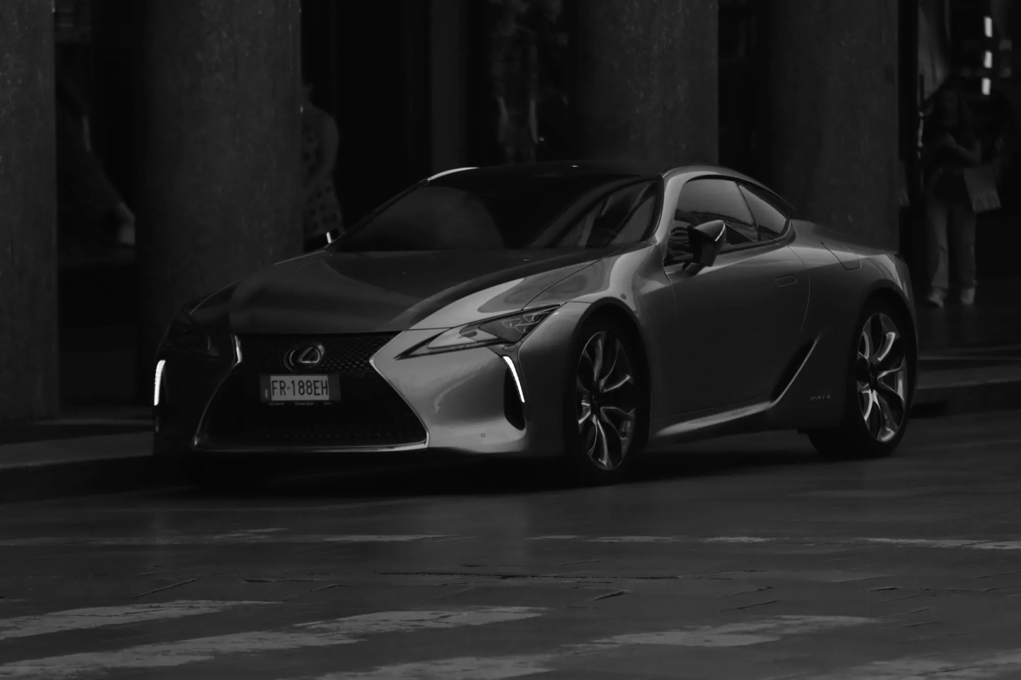 Grey luxury coupe parked at night