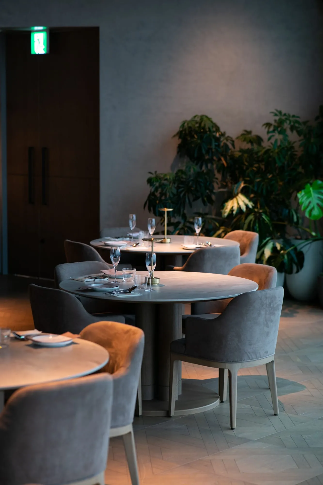 Dimly lit dining room with plush chairs