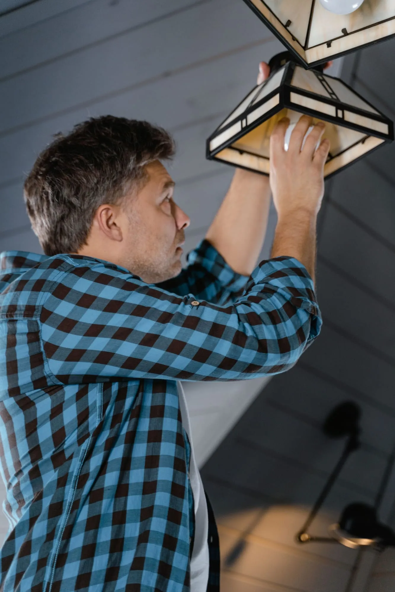 Electrician working on a ceiling fitting