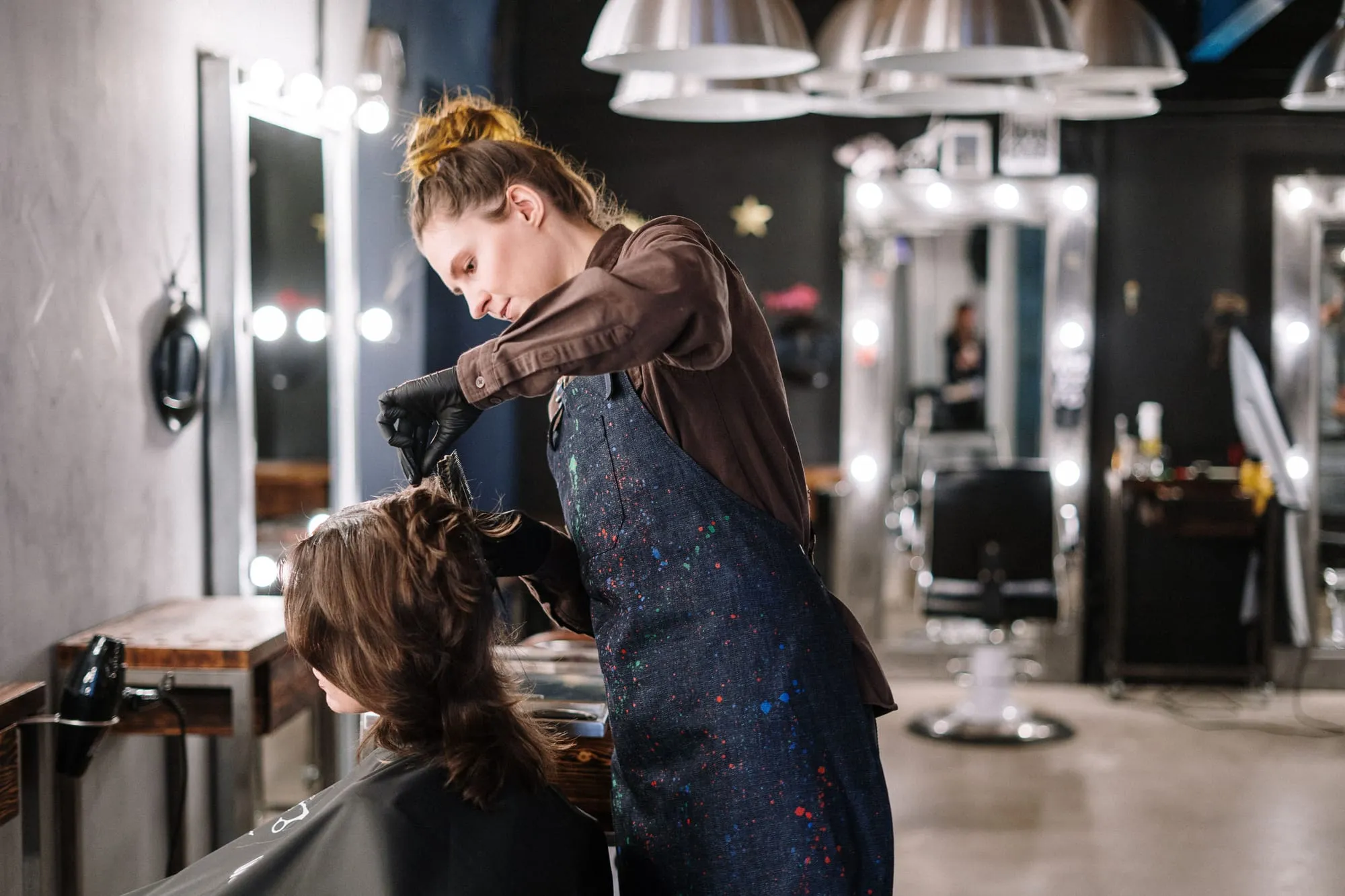 Stylist cutting a client’s hair in the salon