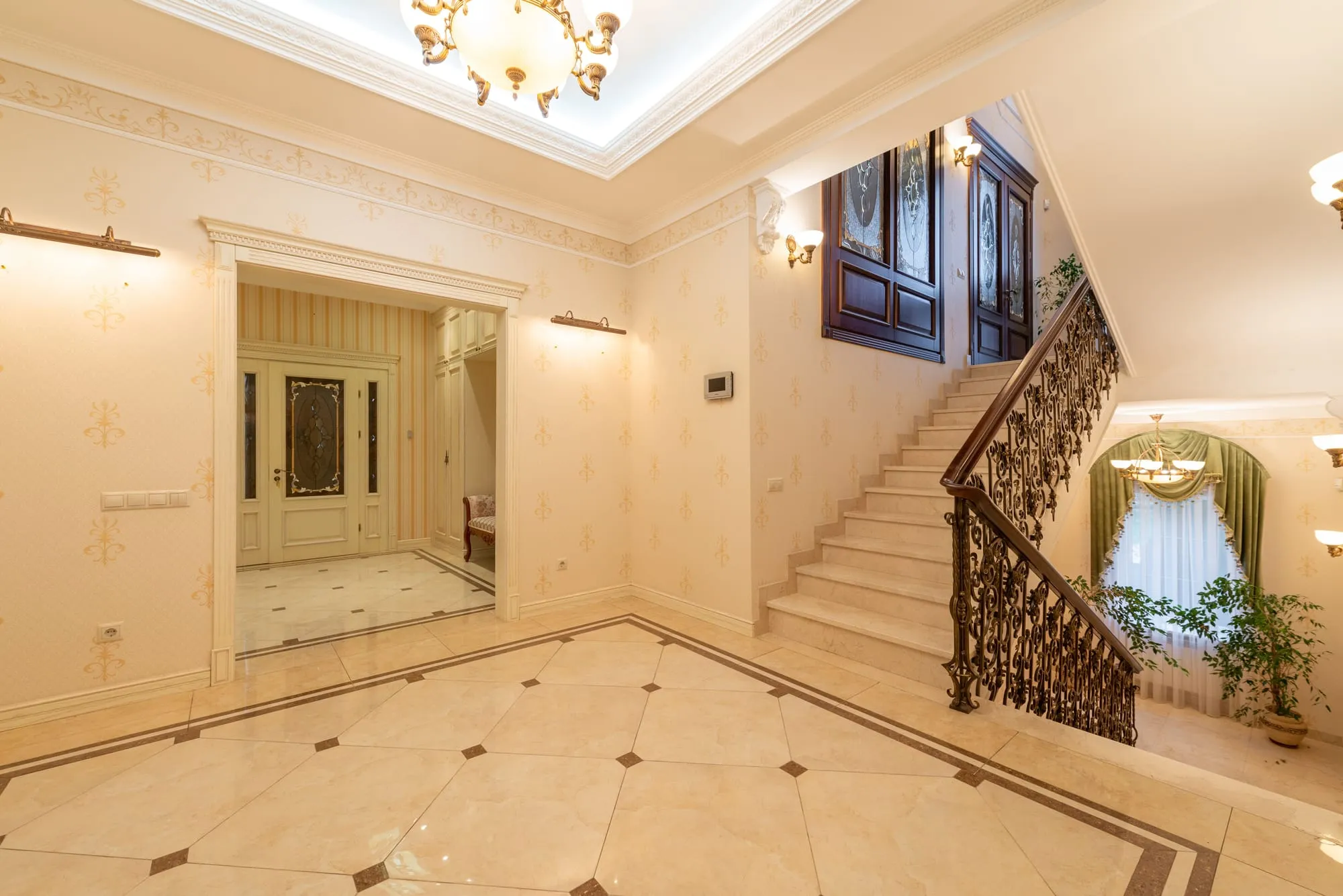 Bright marble entrance hall with a staircase