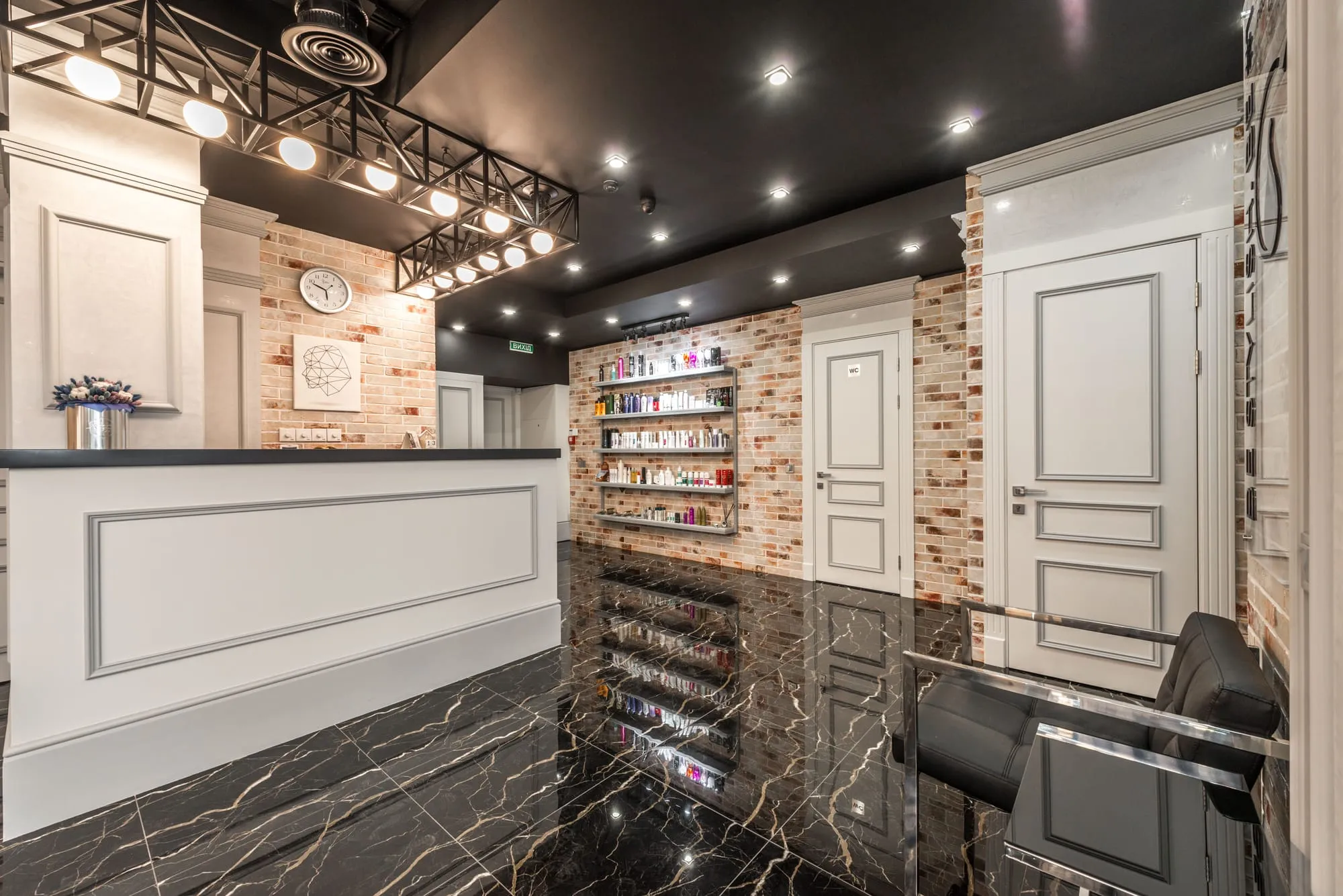 Salon reception with marble floors and soft lighting