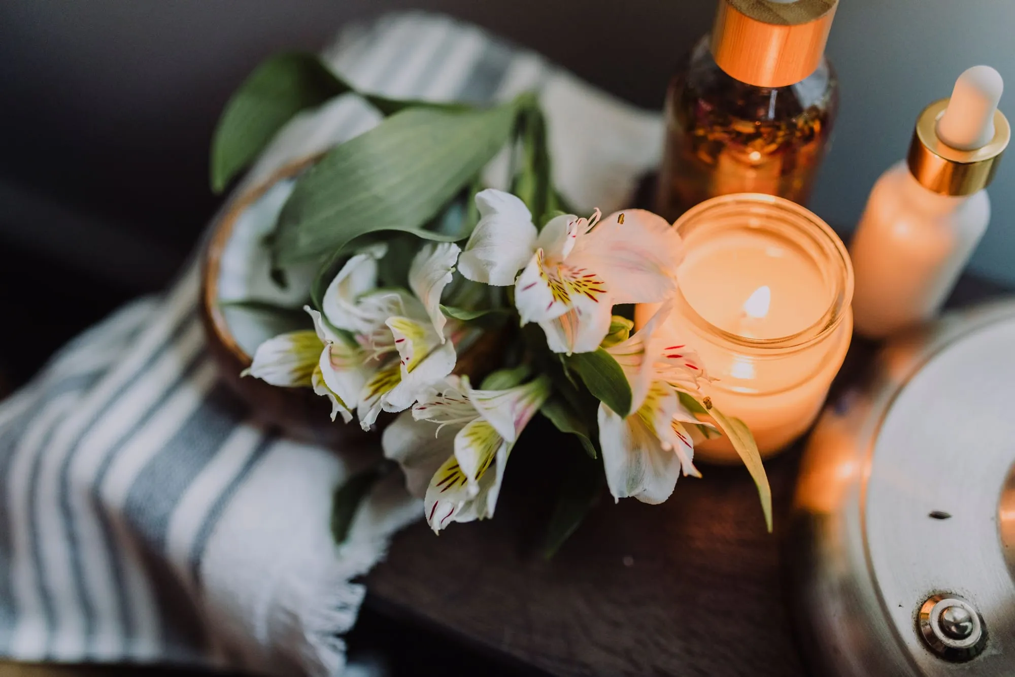 Spa ritual with candles, flowers and oils